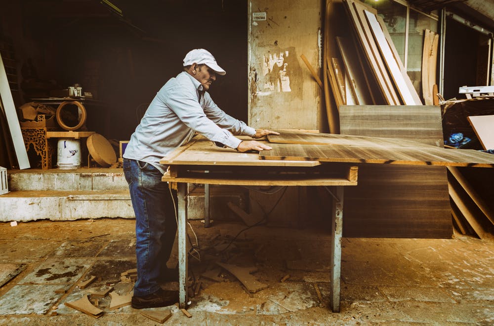 Worker handcrafting an Italian furniture